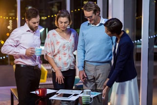 Businesspeople discussing on documents while having coffee in office-1