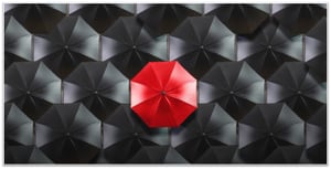 Differentiation Red Umbrella in Black Umbrellas