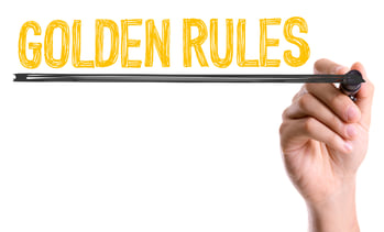 Hand with marker writing Golden Rules