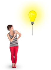 Happy young woman holding a light bulb balloon