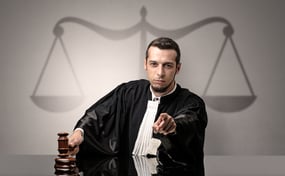 Young handsome judge in black gown making decision