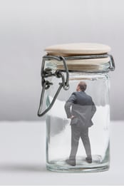 iStock-623276392 - Businessman in a jar with note